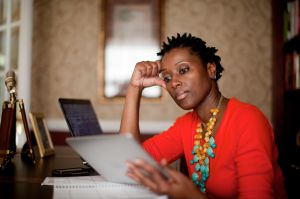 African-American woman in home office with tablet