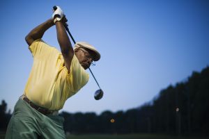 Mature man on driving range