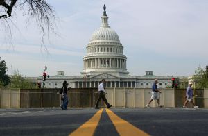 Pedestrians walk past the US Capitol and
