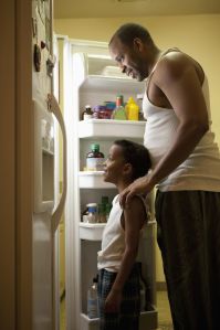 Father and son looking in the refrigerator